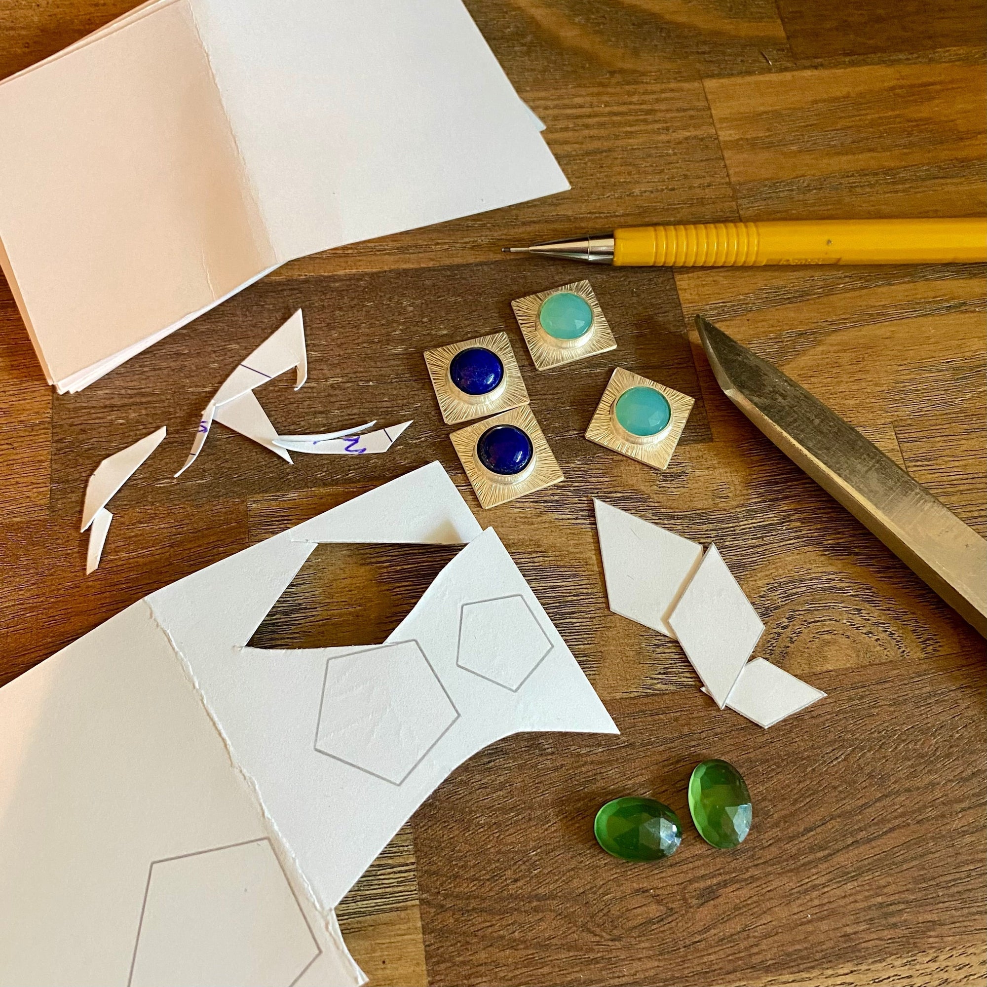 jewelry designs in progress on a table. Houston, tx jewelry designer lindsey johnson of geophilia studio.